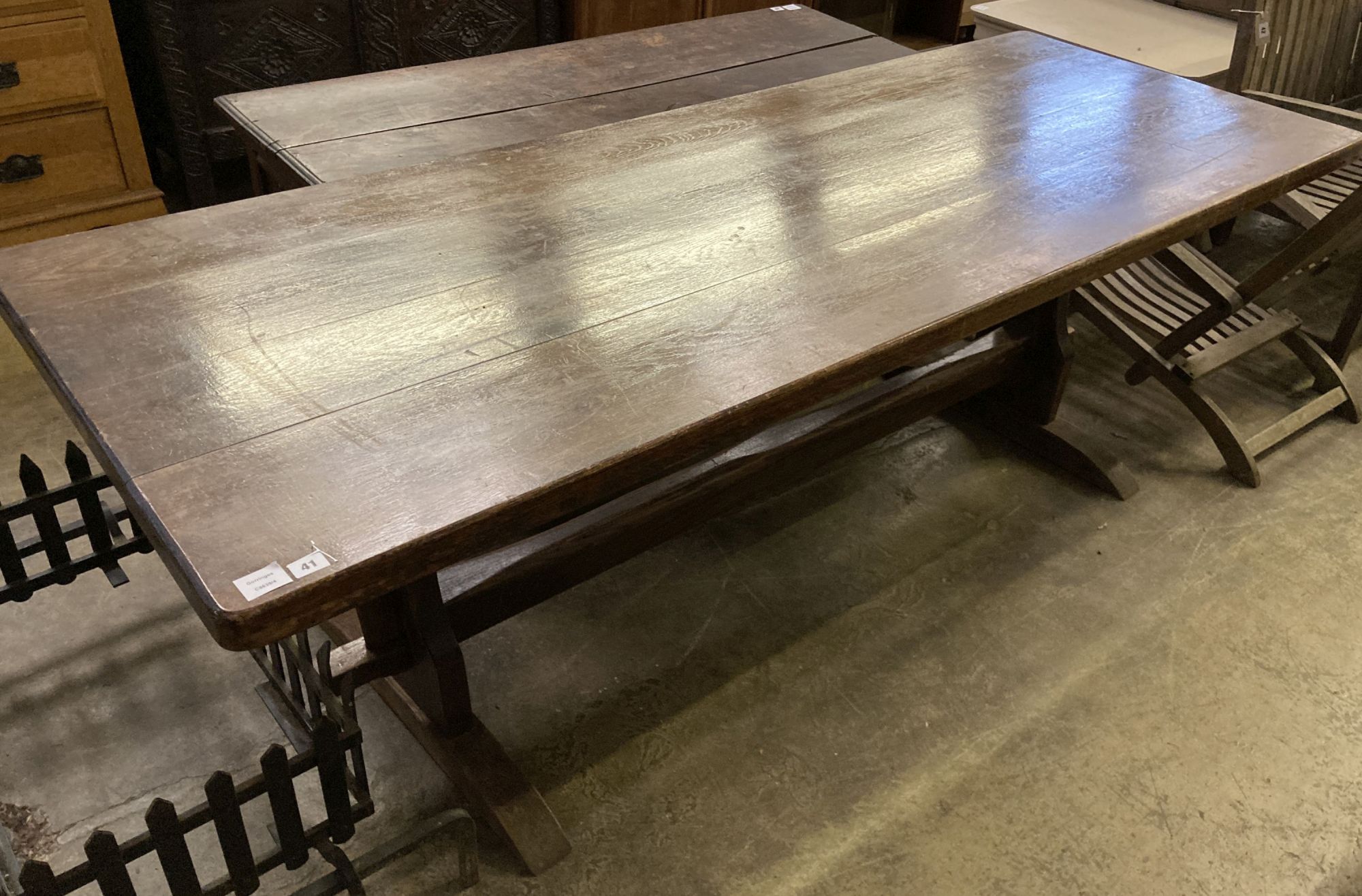 An 18th century style rectangular refectory dining table on trestle end supports, length 212cm, depth 80cm, height 74cm